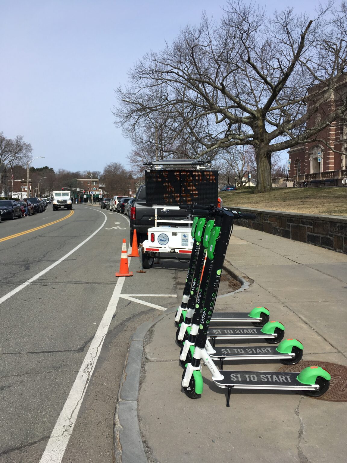 Scooters lined up on the street.