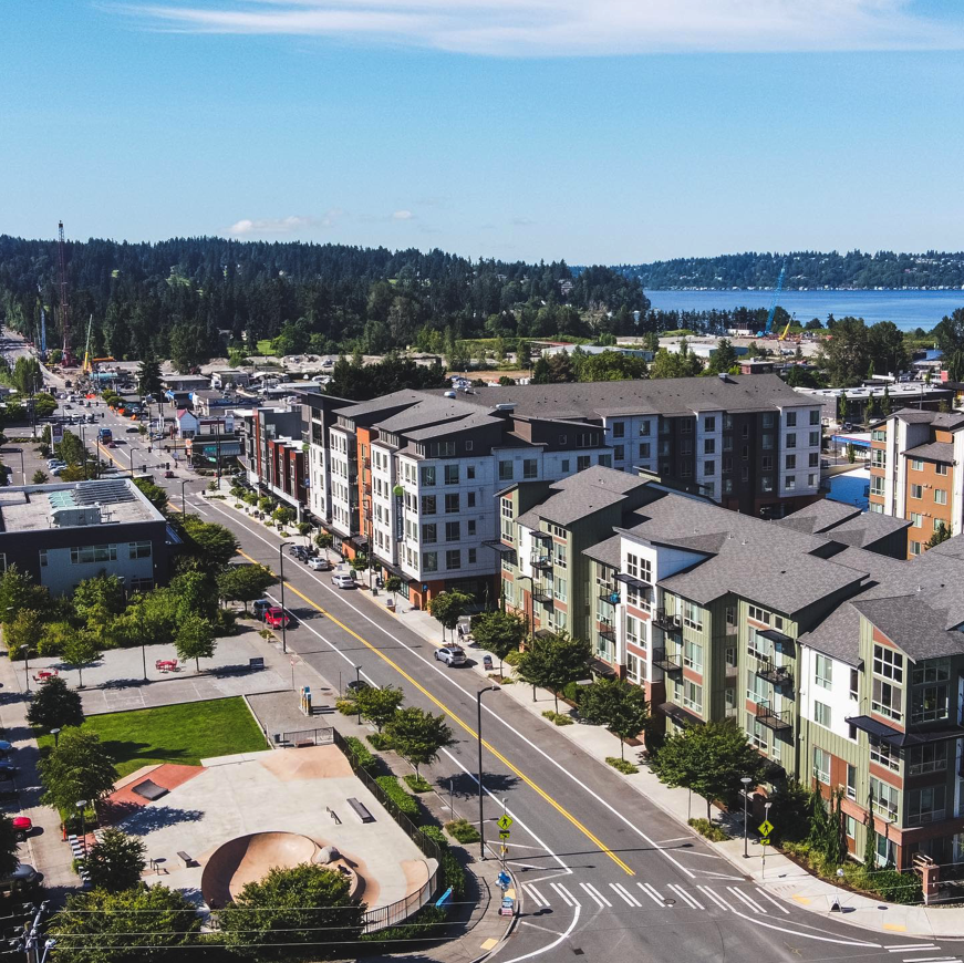 Dense residential development along a tree-lined road.