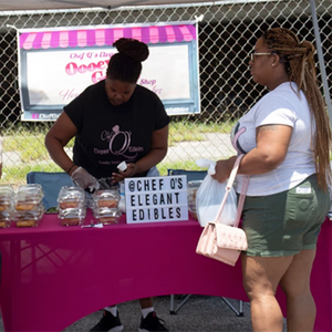 A community member buying baked goods at a stand