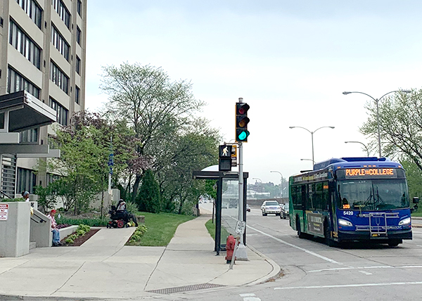 Bus at intersection by housing in Milwaukee