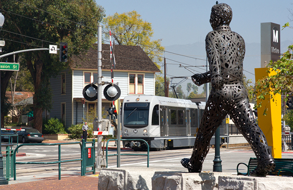 A statue crossing a railroad track