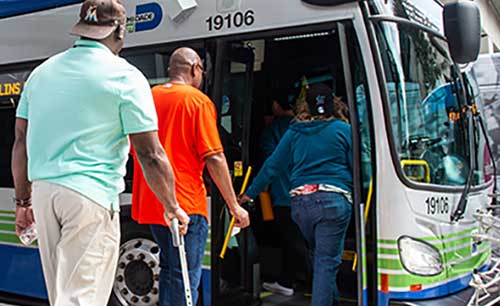 Man with cane and two others board bus Credit Miami-Dade County DTPW