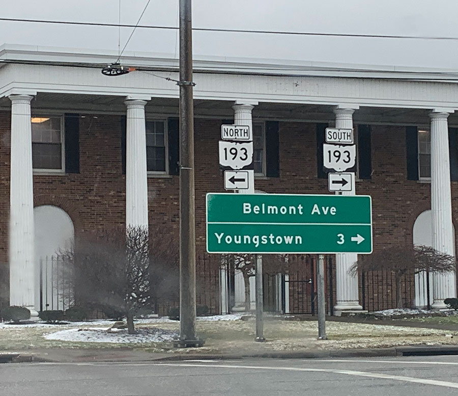 Signs for Belmont Avenue and Youngstown with big building with columns