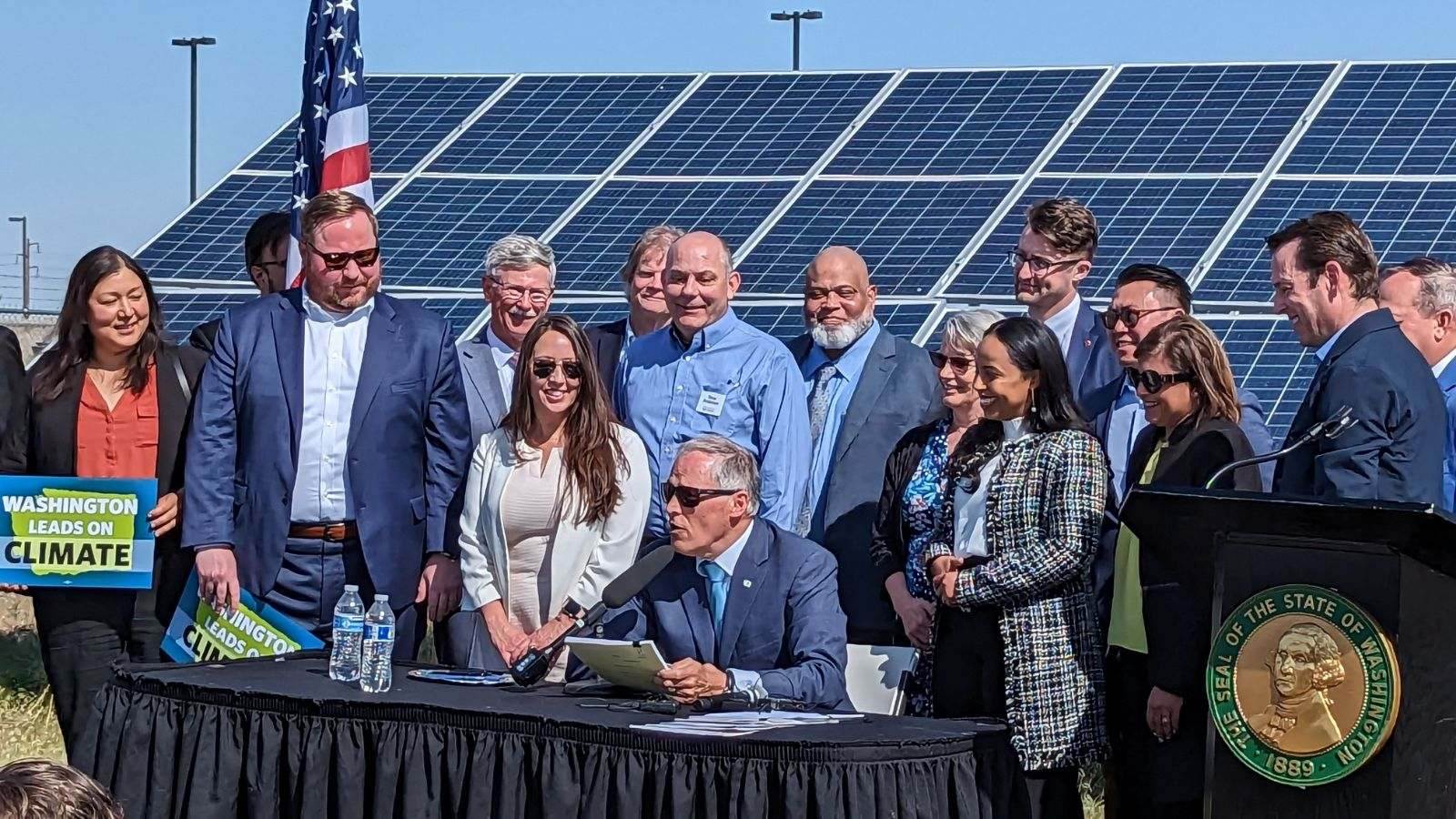 Photo from Futurewise shows Governor Inslee signing climate legislation in Washington State, with supporters in the background
