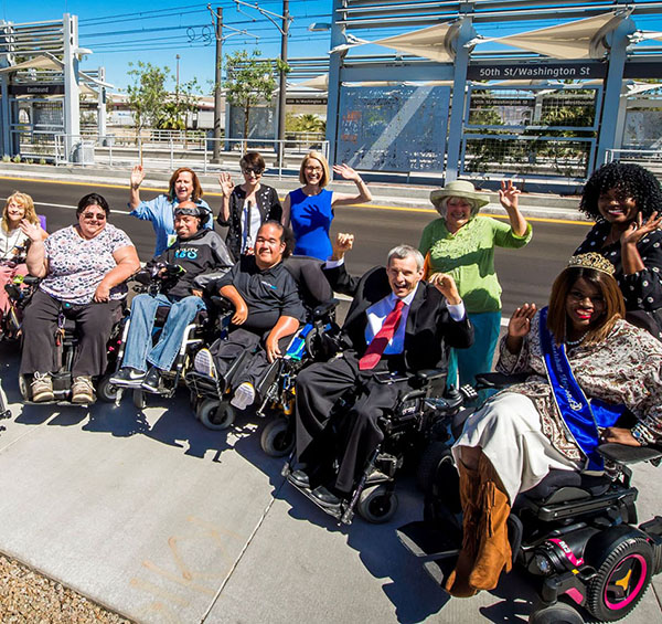 A group of people with disabilities across from 50th street LRT station in Phoenix. Credit Valley Metro