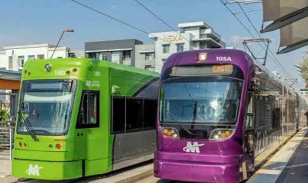 Streetcar and Light Rail vehicles with buildings in background