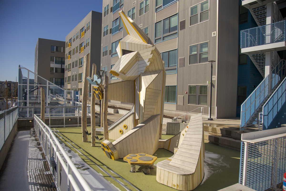 A playground structure in the shape of a fox outside Thrive housing. Credit Denver Housing Authority